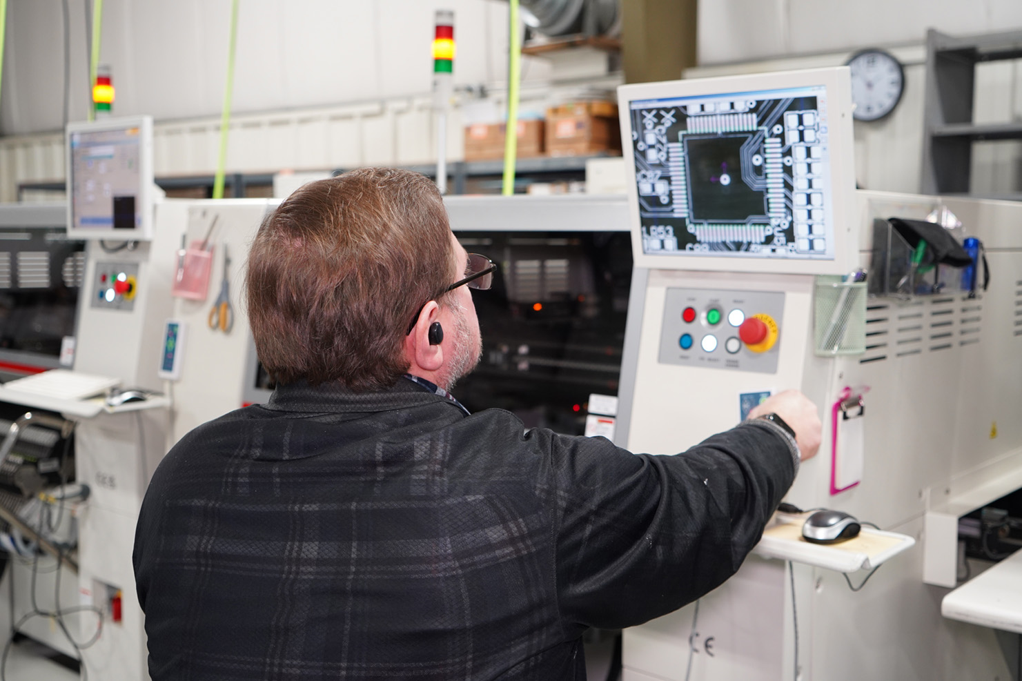 Man at SMT Equipment looking at alignment