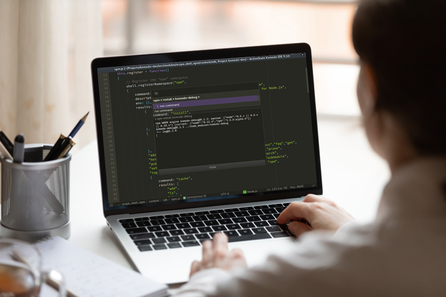 Woman at computer writing scrip for software