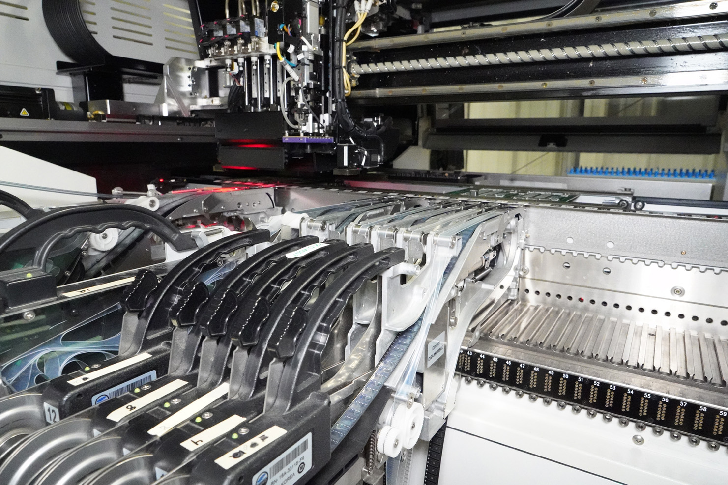 Component reels feeding into SMT machine