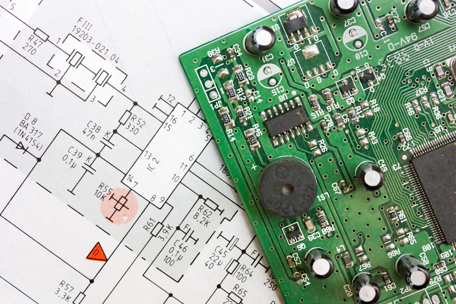 PCB Board laying on a computer generated drawing of operation schematics
