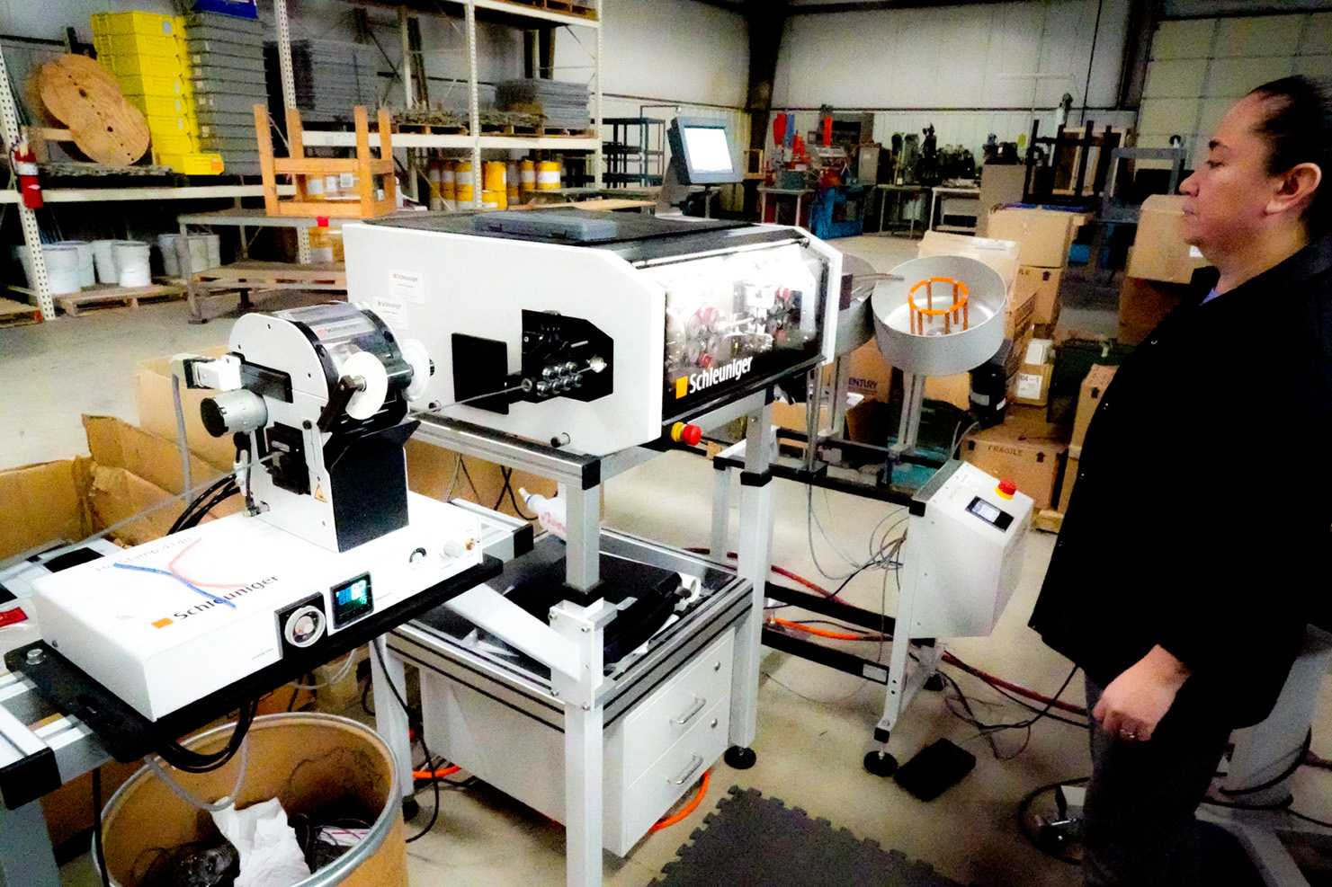 Woman operating wire cutting and stripping machine