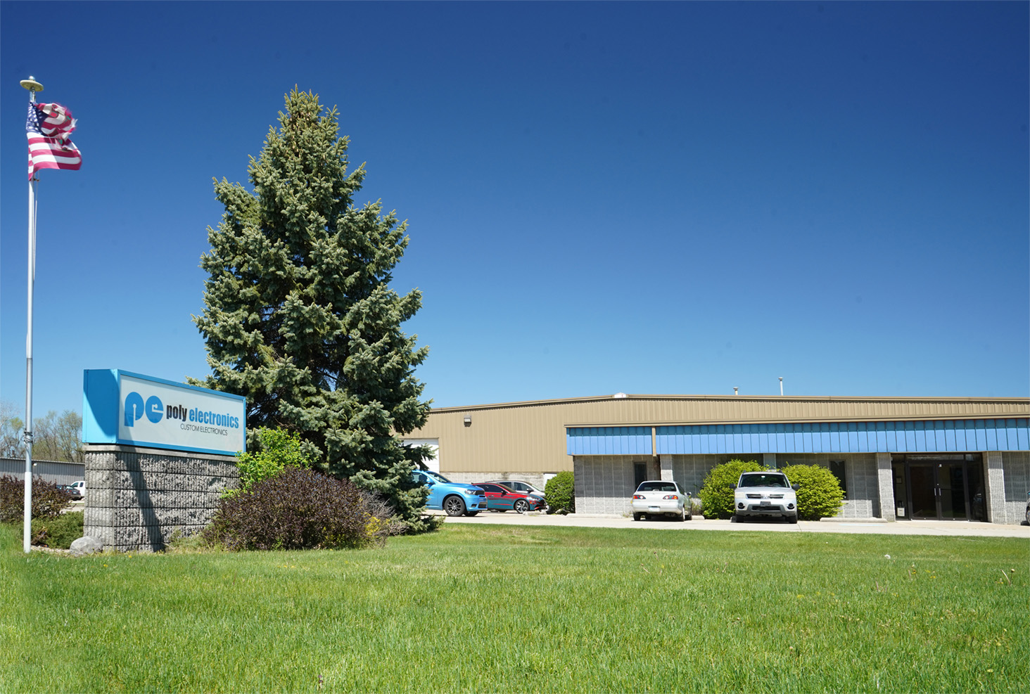 Poly Electronics sign in front of headquarters
