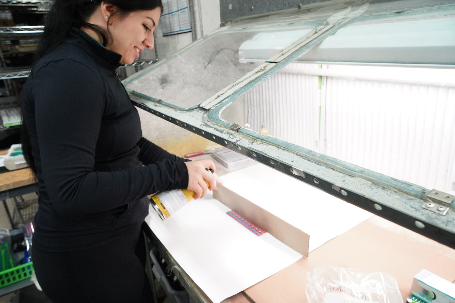 Woman spraying PCB Board with Conformal coat ing